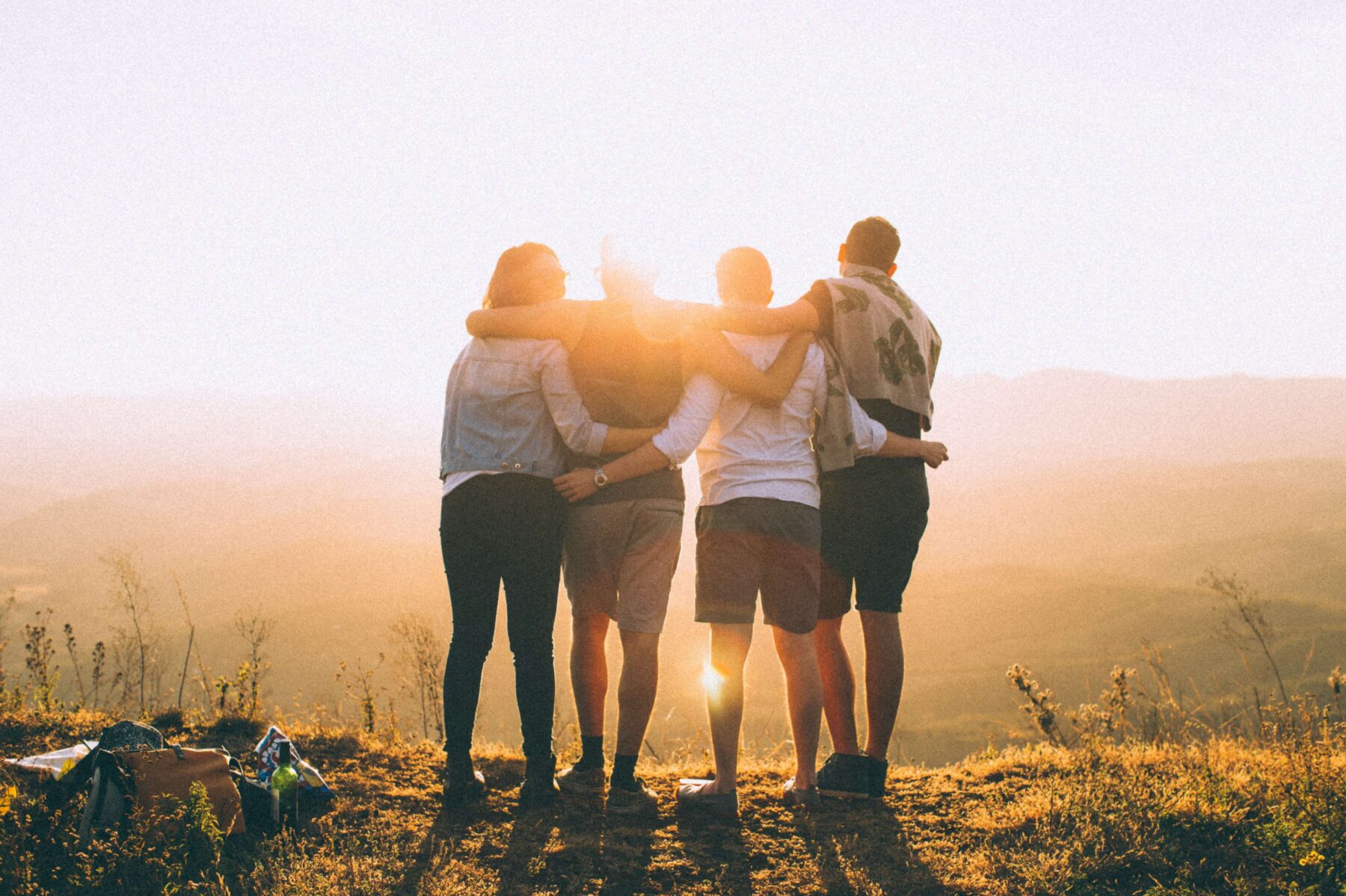 friends on a hike watching a sunset