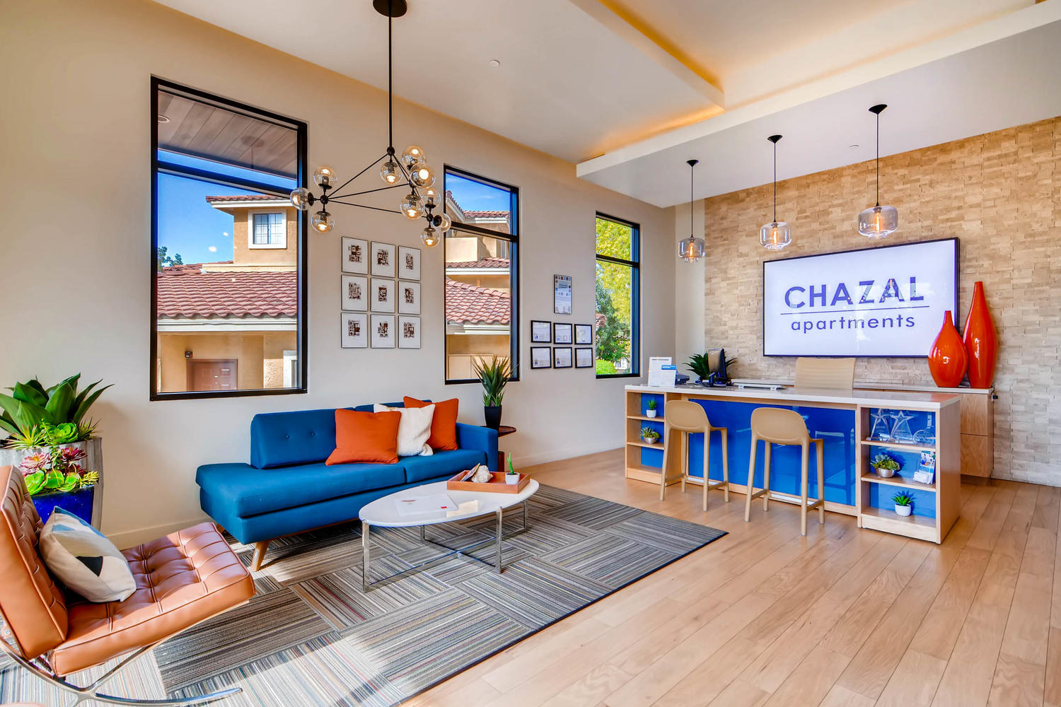 The front desk with the name Chazal Apartments on the sign on the wall