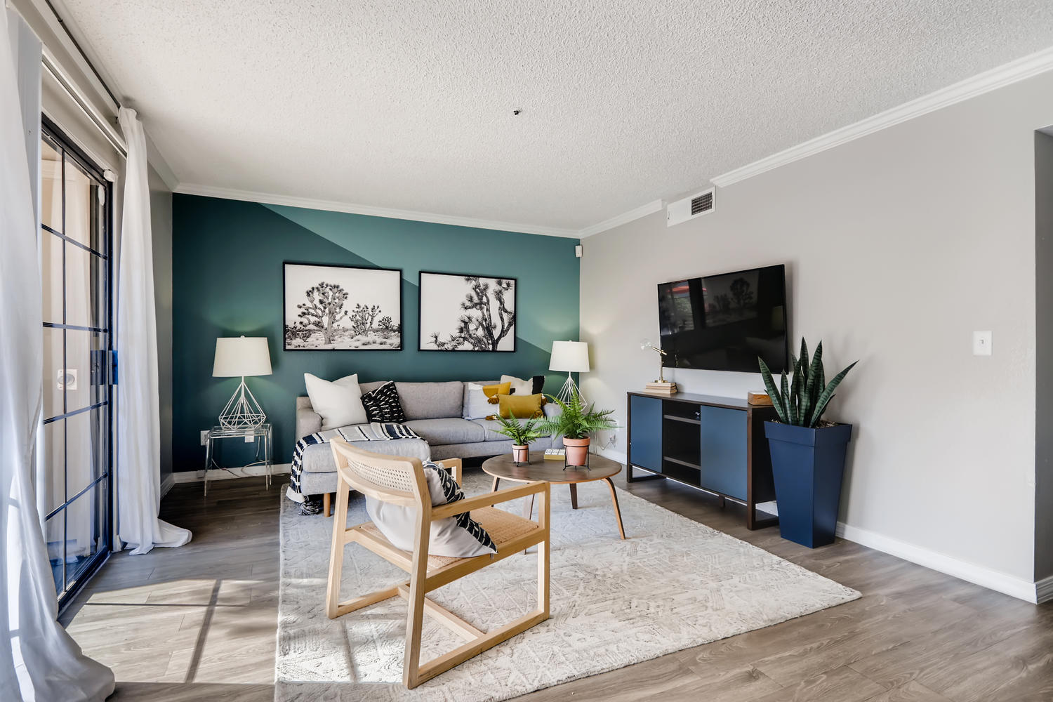 view of living room with green accent wall and L shaped couch