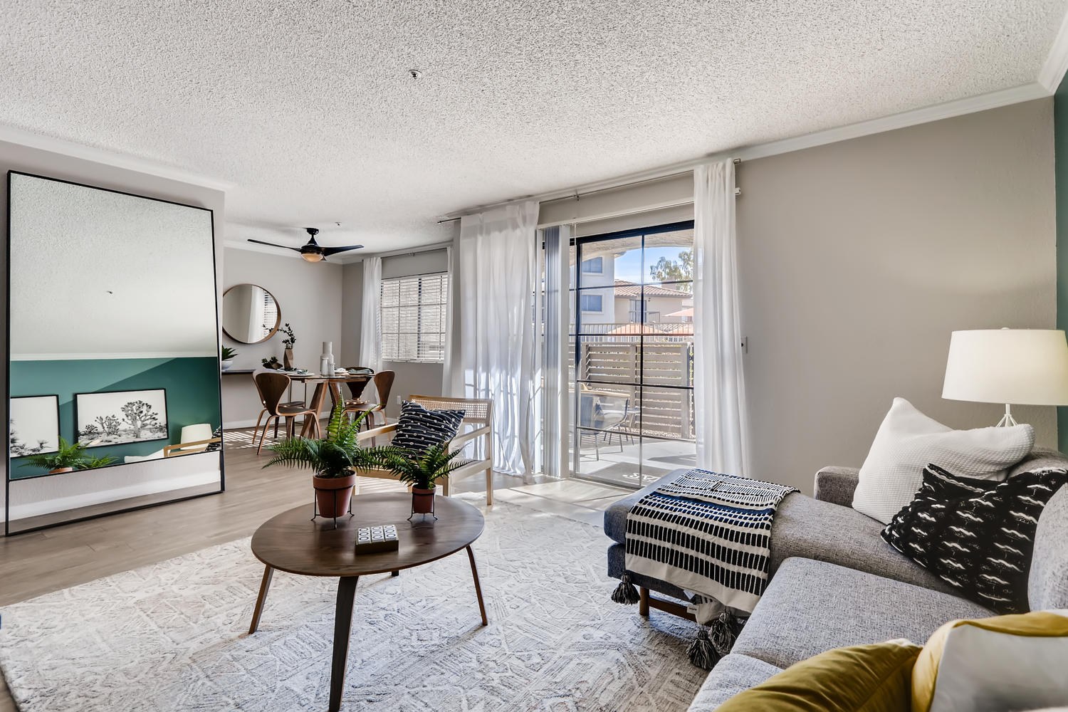 view of living room and dining area with L shaped grey couch