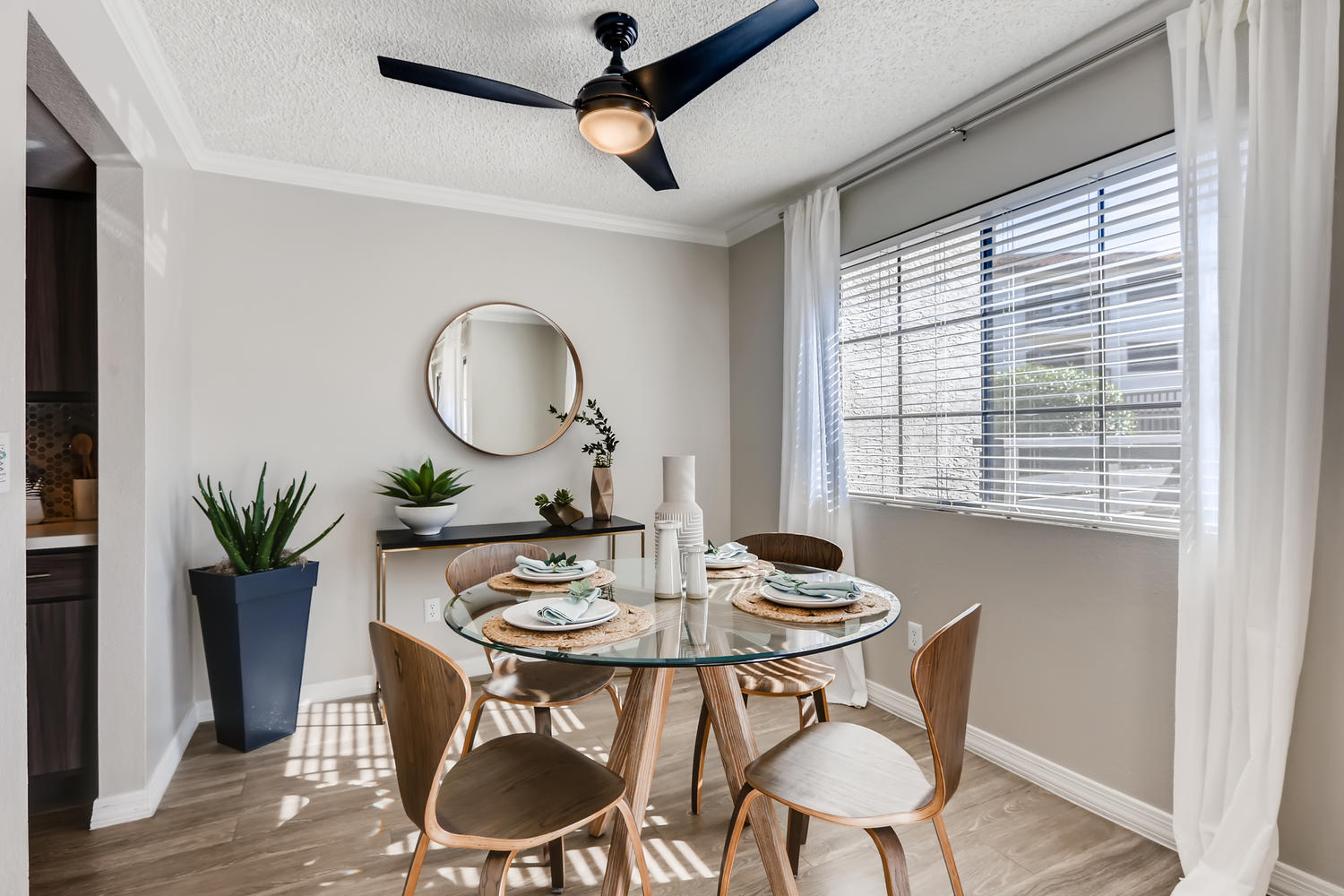 view of dining area with small circle table and 2 panel window and wood floors