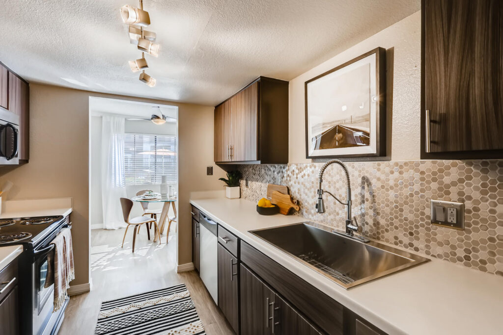 Kitchen with brown tone cabinets at Chazal Scottsdale apartments near Fashion Square
